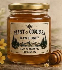 Jar of Flint & Compass raw honey with a wooden honey dipper and yellow wildflowers